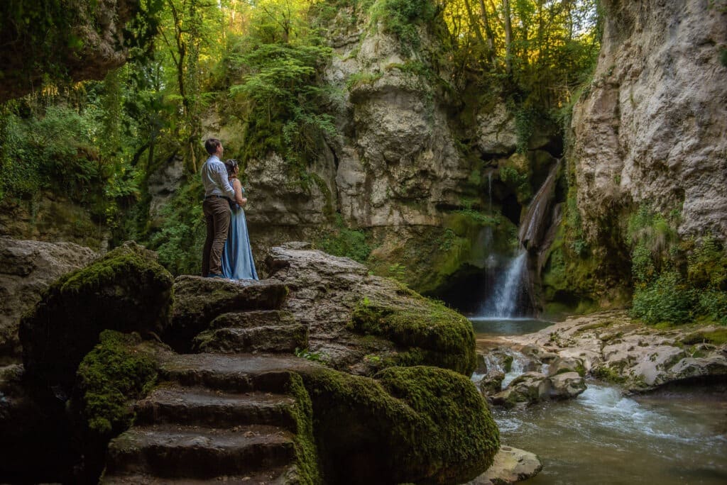 couple standing near a secret waterfall during a photo session near Montreux