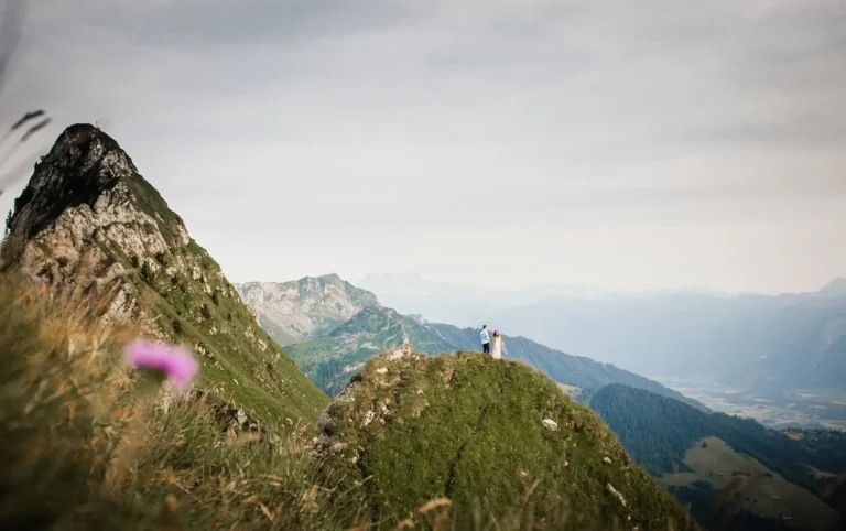 Summer sunset elopement on a mountain ridge near Montreux, Switzerland – couple standing on summit