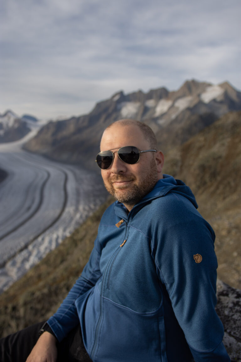 Solo male portrait in front of a glacier in switzerland