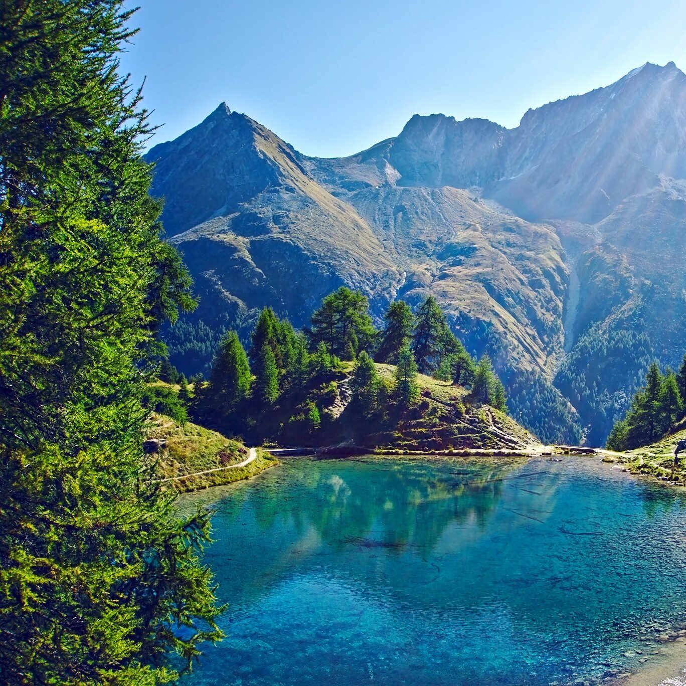 Hidden alpine lake in the Swiss Alps during sunrise portrait session