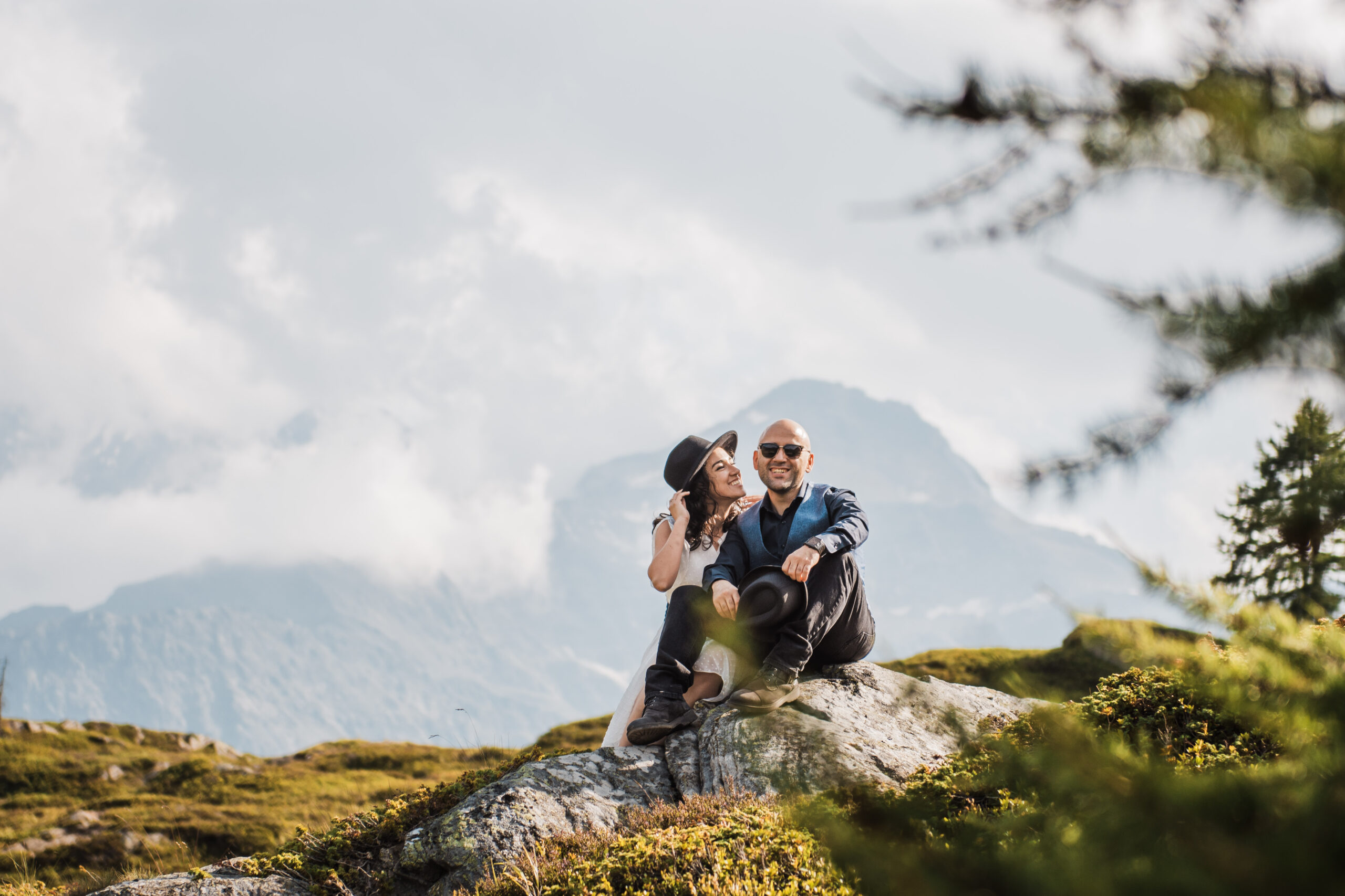 Couple laughing together during an outdoor photography session in the Swiss Alps
