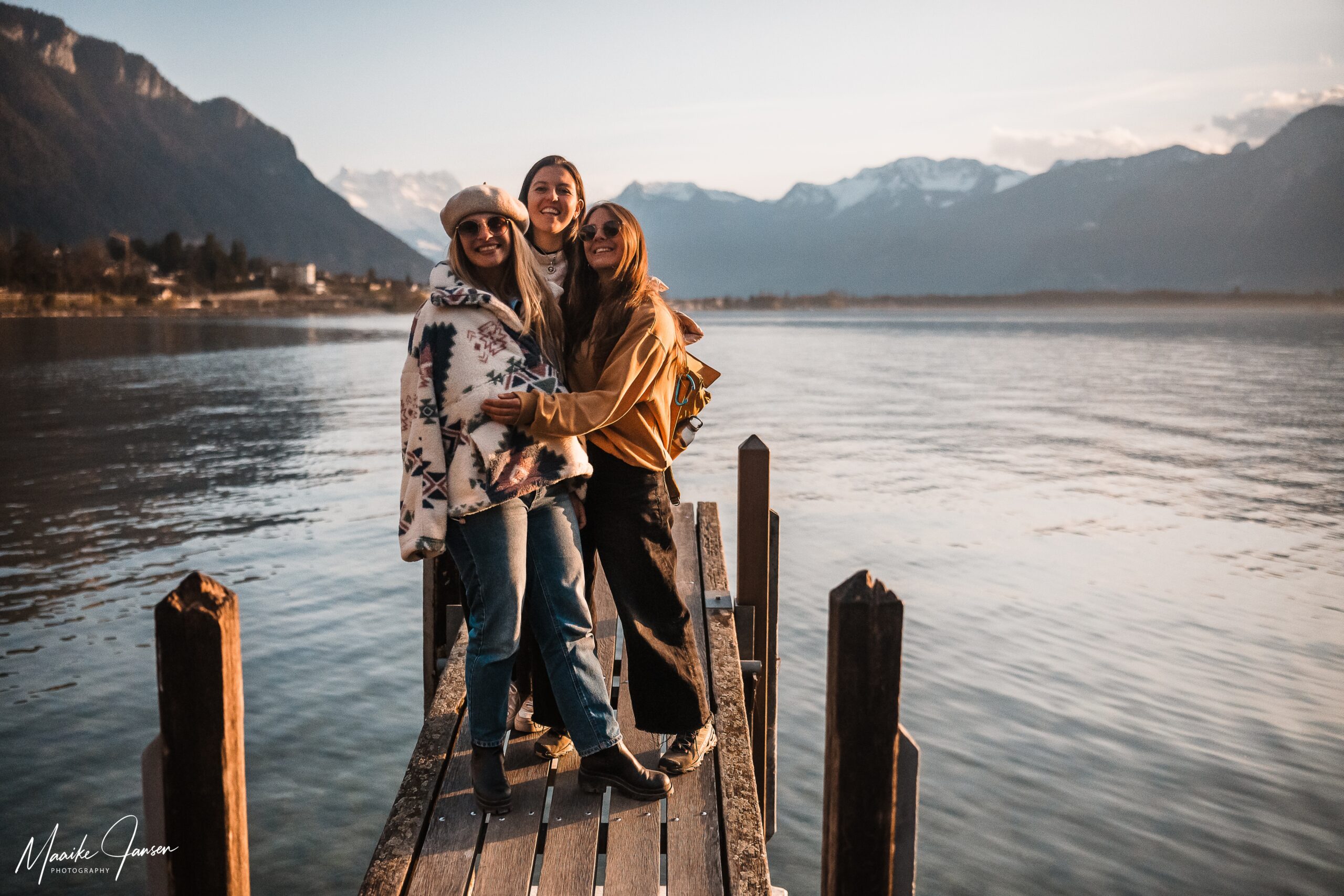 Group of female friends on a pier next to chillon castle during a photo session