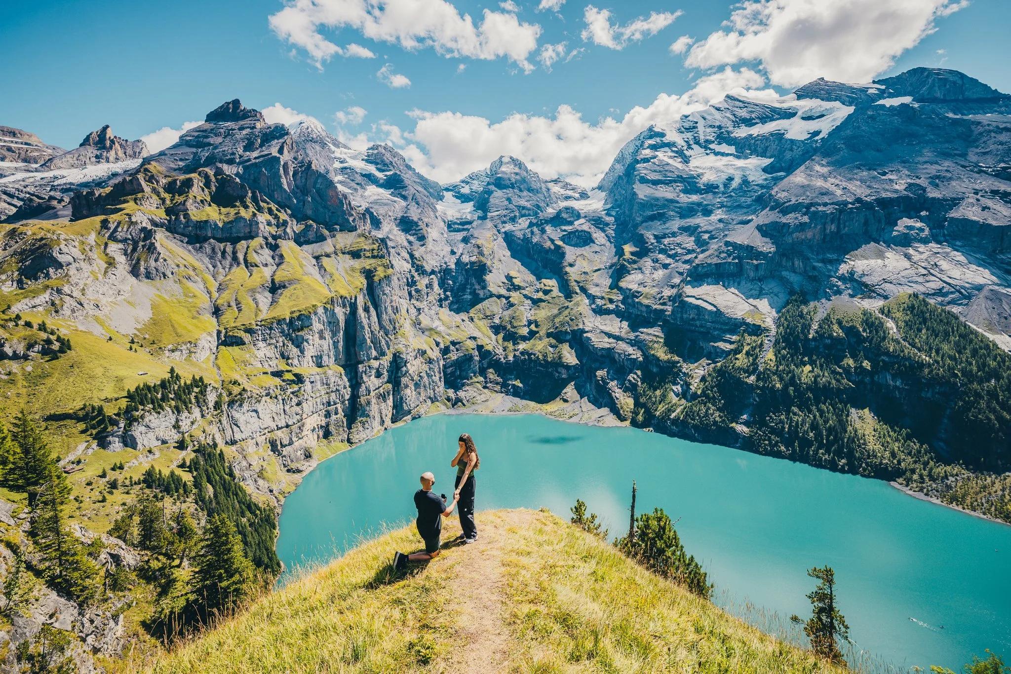Romantic proposal moment overlooking Oeschinen Lake in the Swiss Alps