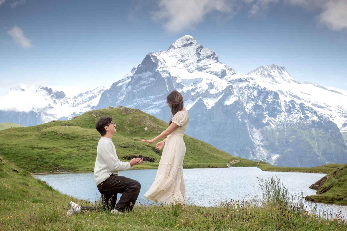 Couple during a proposal in Grindelwald with mountain views in the Swiss Alps