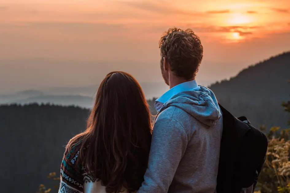 Couple looking at a sunset during a bespoke adventure photo session
