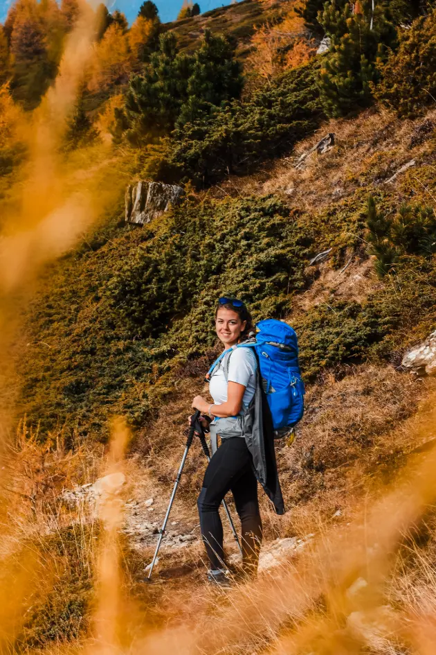 Woman smiling on a trail during an adventure photo session in switzerland