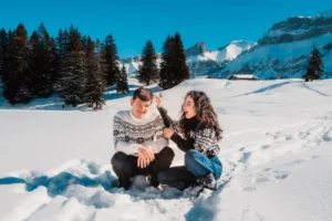 couple playing in the snow during a winter portrait session in the swiss riviera