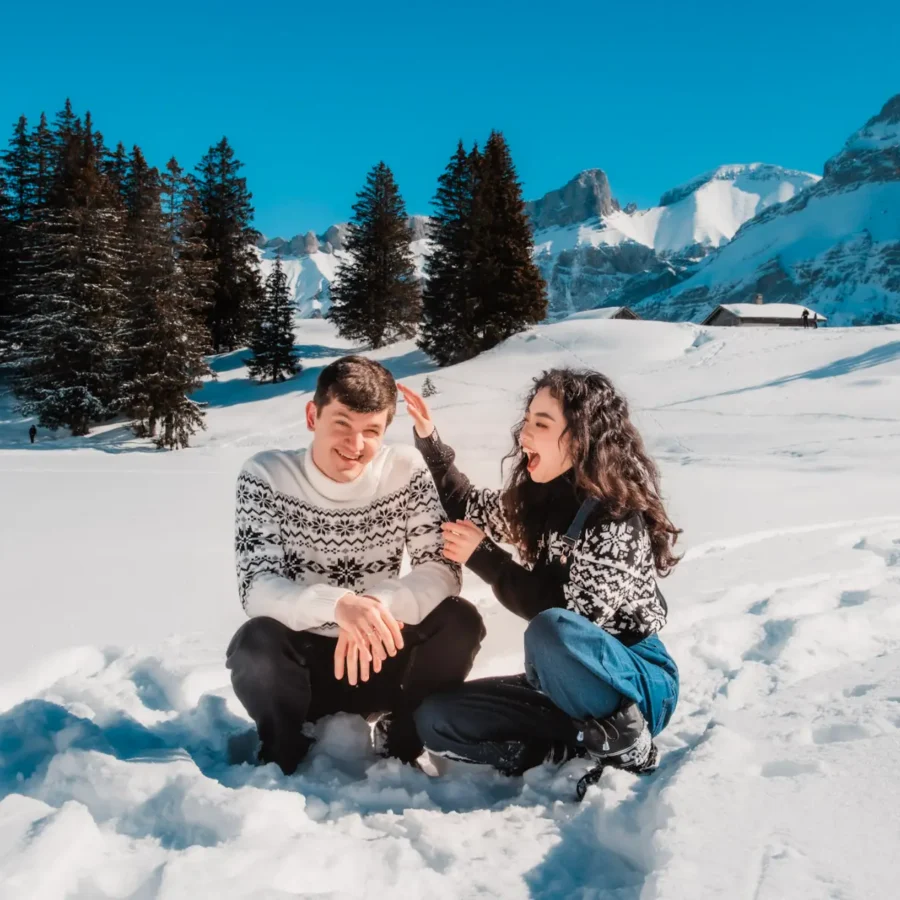 couple playing in the snow during a winter portrait session in the swiss riviera