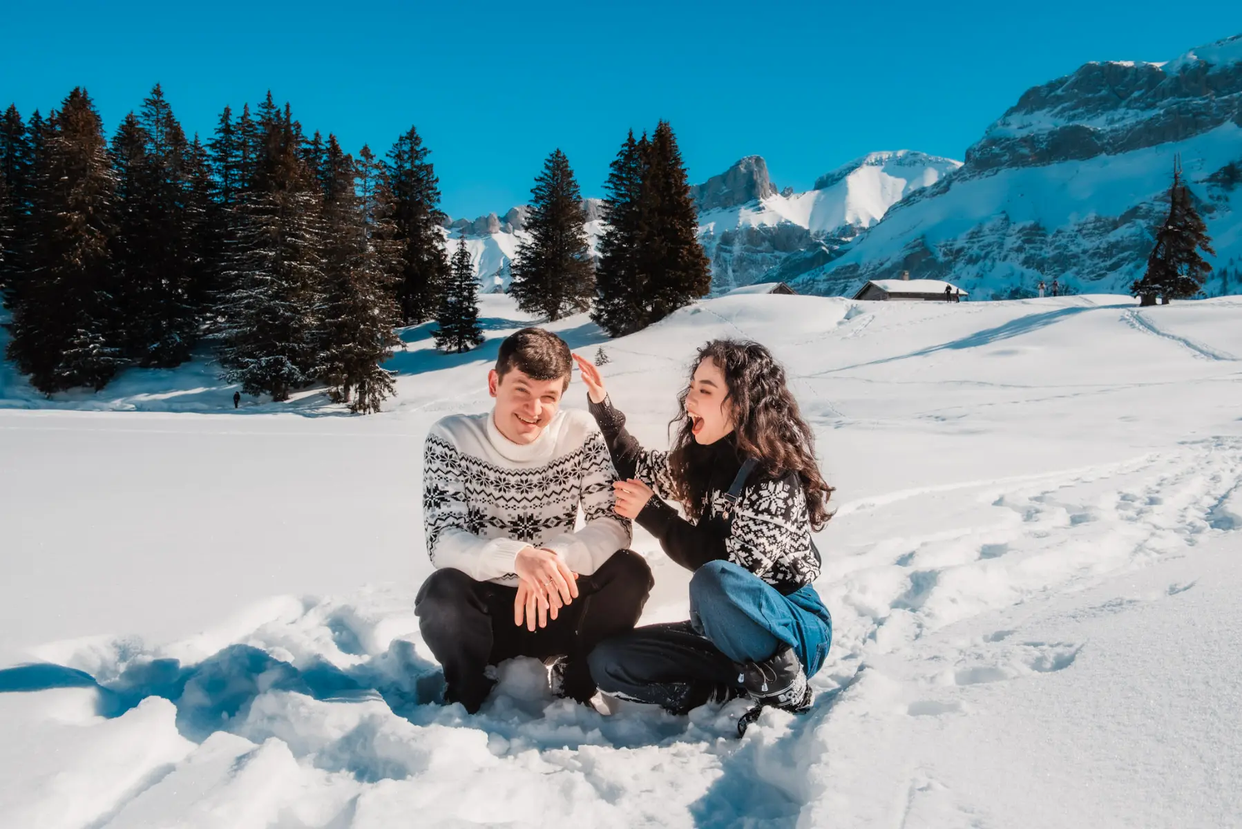 couple playing in the snow during a winter portrait session in the swiss riviera