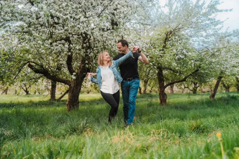 couple dancing in an apple orchard in switzerland
