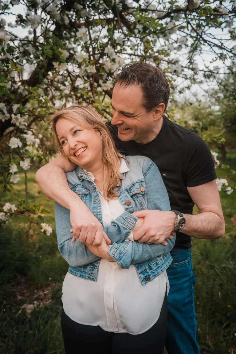 husband hugging his wife during a spring portrait session in switzerland