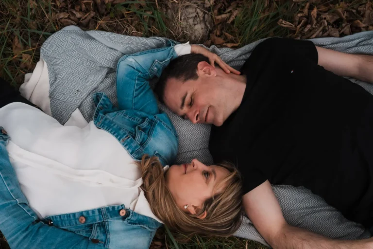 couple laying on a blanket