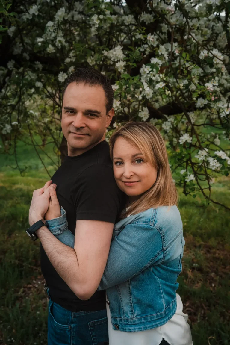 woman hugging her husband and looking at the camera