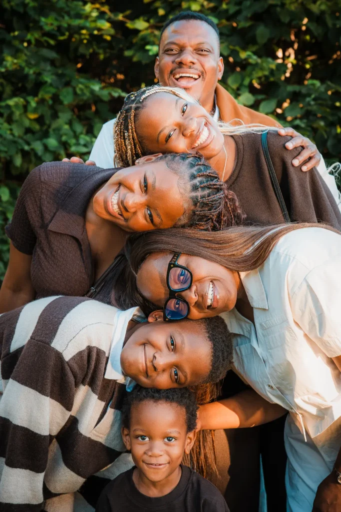 Genuine family laughter captured during a relaxed outdoor portrait session on the shores of Lake Geneva.