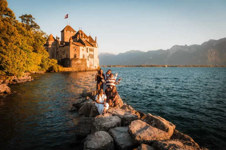 Parents and older children sharing a joyful moment during a family session by Lake Geneva.