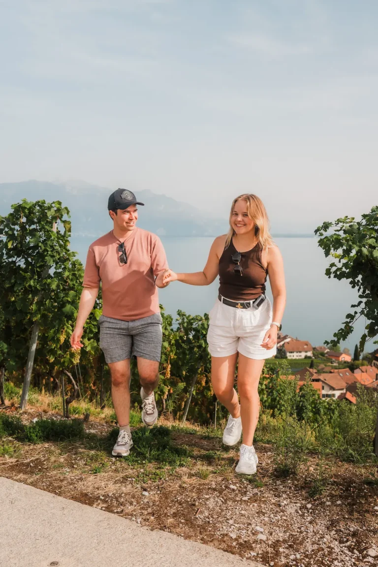 Dimitris and Alisa laughing together moments after their surprise proposal in Lavaux.