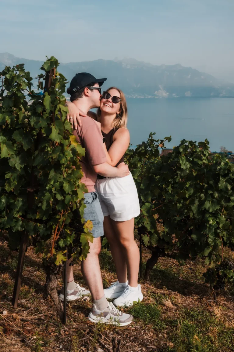 Newly engaged couple overlooking the Lavaux vineyards and Lake Geneva in Switzerland.