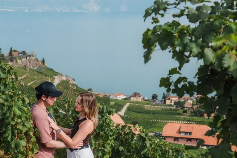 couple looking at eachother after a surprise proposal in the lavaux vineyards in switzerland