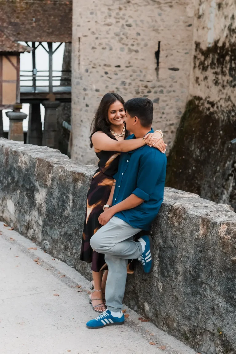 Newly engaged couple laughing together near Château de Chillon
