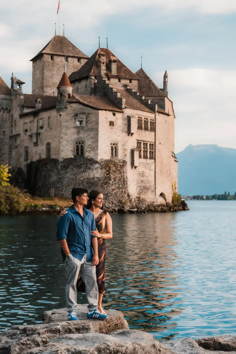 Newly engaged couple sharing a quiet moment beside Chillon Castle